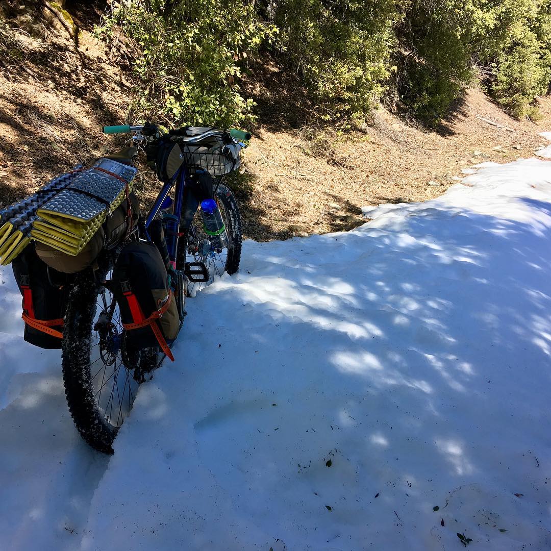 “Don’t go over the mountains, there’s still snow up there…” one voice whines, “Go around and have a relaxing ride” While another voice grunts, “Fuck it, there ain’t that much…” As usual we reached a compromise